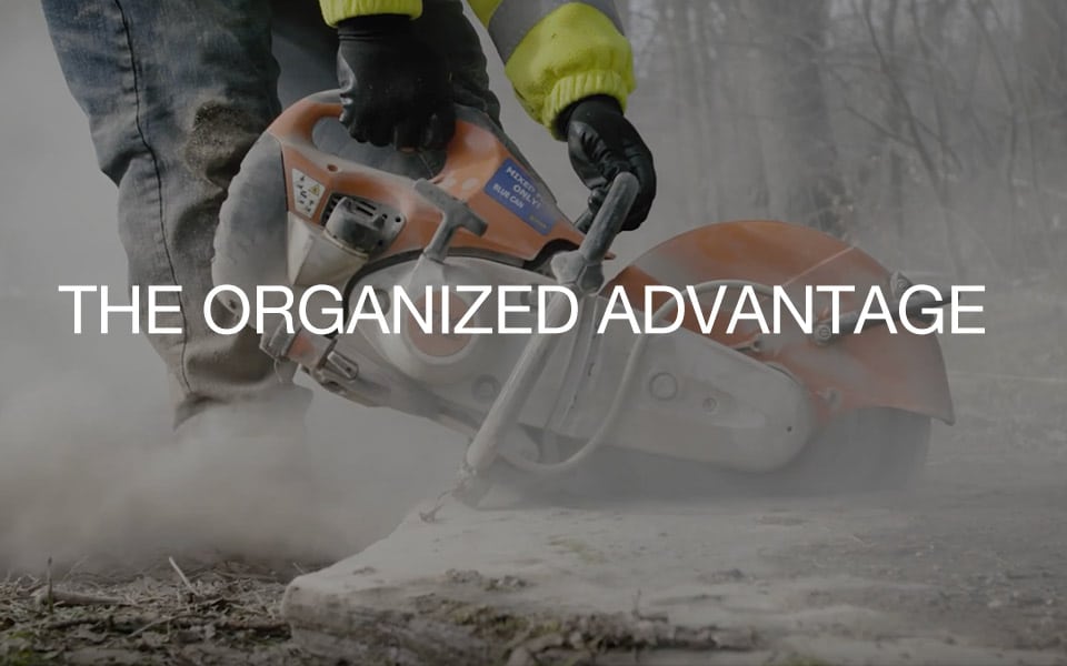 "The Organized Advantage" Text over image of stone saw